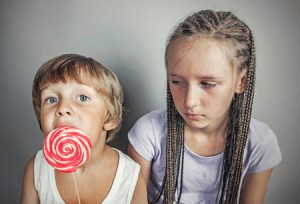 35811677 - sister jealous brother who eats candy